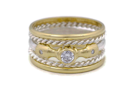 Lighthouse 5 Ring Stacked Set featuring Lighthouse Ring featuring a large ethical lab-grown diamond in the center, offset by 2 smaller ethical diamonds, in an 18K fairmined gold setting. This ring has 2 fairmined silver rope twist rings either side, and 2 x 18K fairmined gold thin plain bands on top and bottom.
